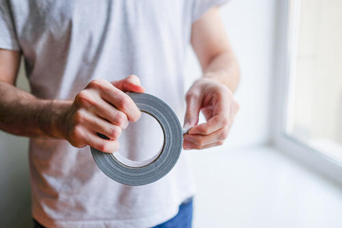 絶縁テープを持つ男性のイメージ画像